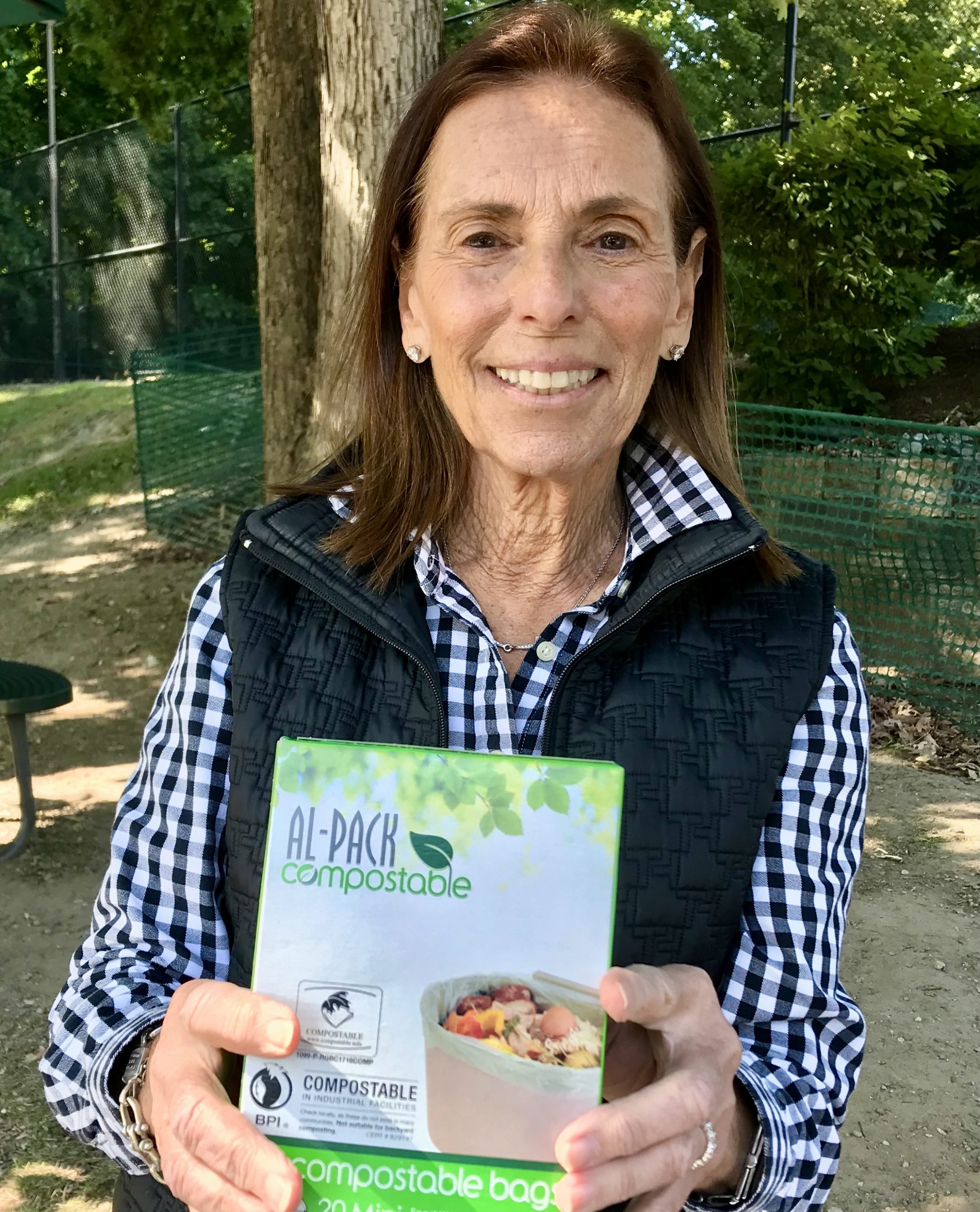 Diane with Compostable Bags Demonstrating Compostable Bags that can be purchased to line the compost container for food recycling